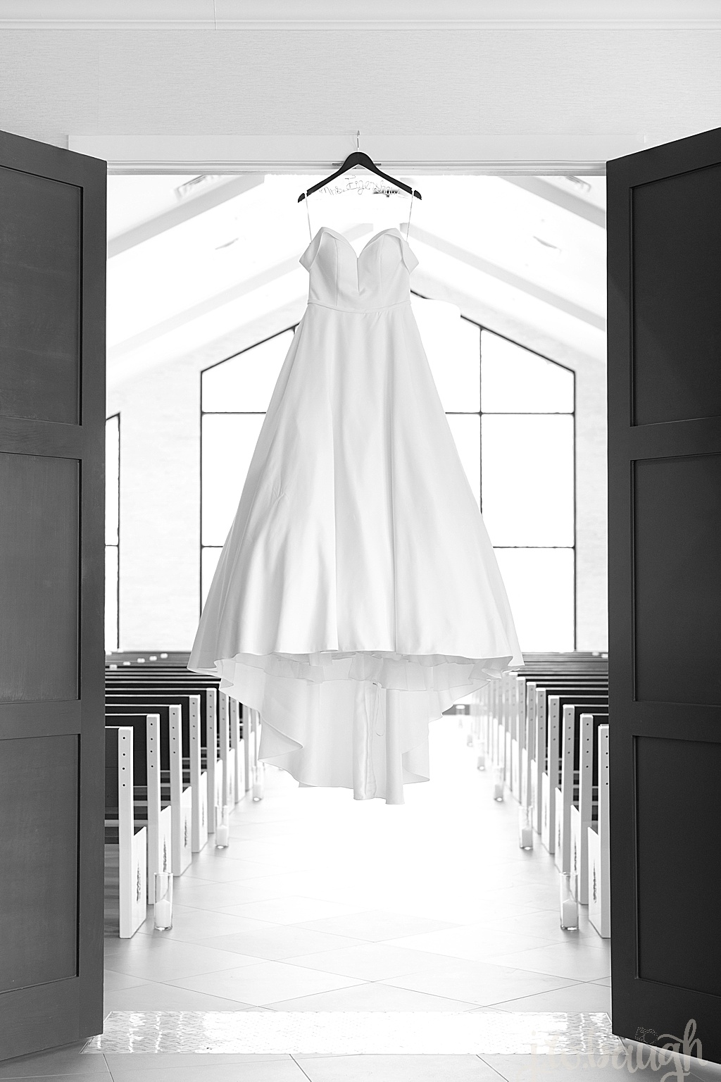 wedding dressing hanging from luminaire chapel doors