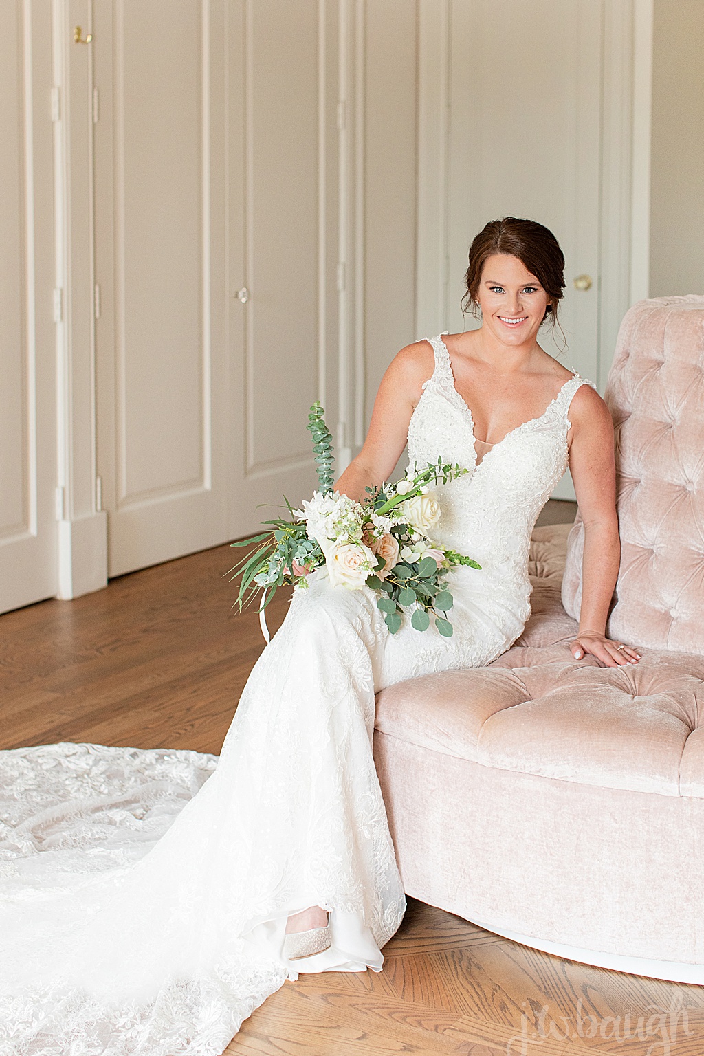 bride sitting on pink velvet chair