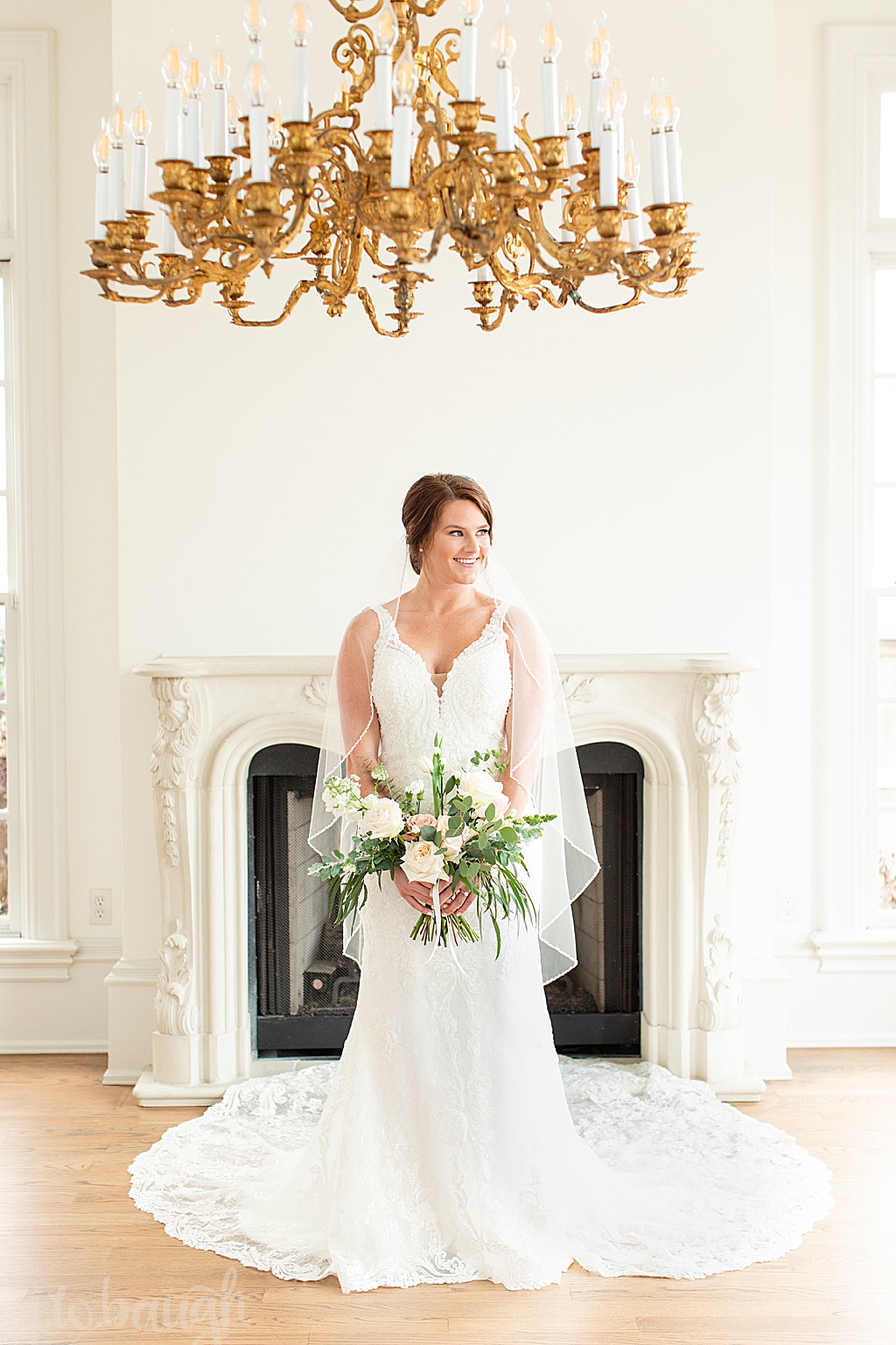 creative chateau bride in front of fireplace